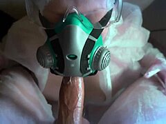A masked girl in a protection suit and gas mask gives a blowjob during the Covid 19 epidemic